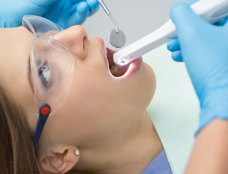 Dentist performing a dental exam using an intraoral camera