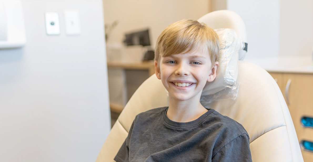 Young boy smiling in dental chair