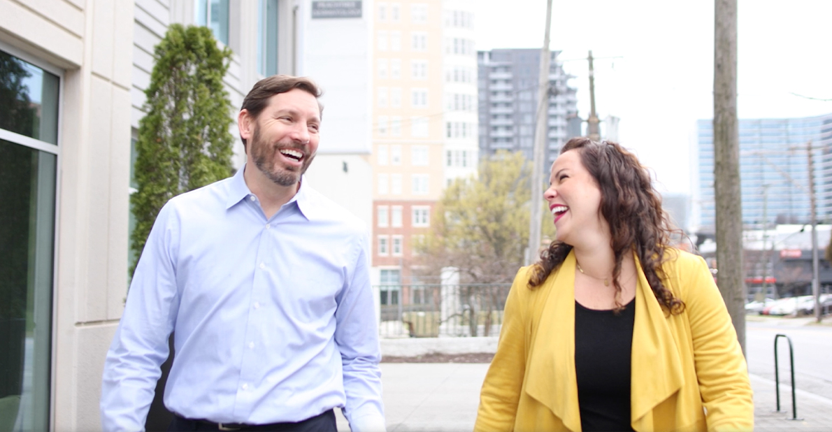 Two dentists laughing on city street