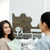 female patient speaking with a dentist