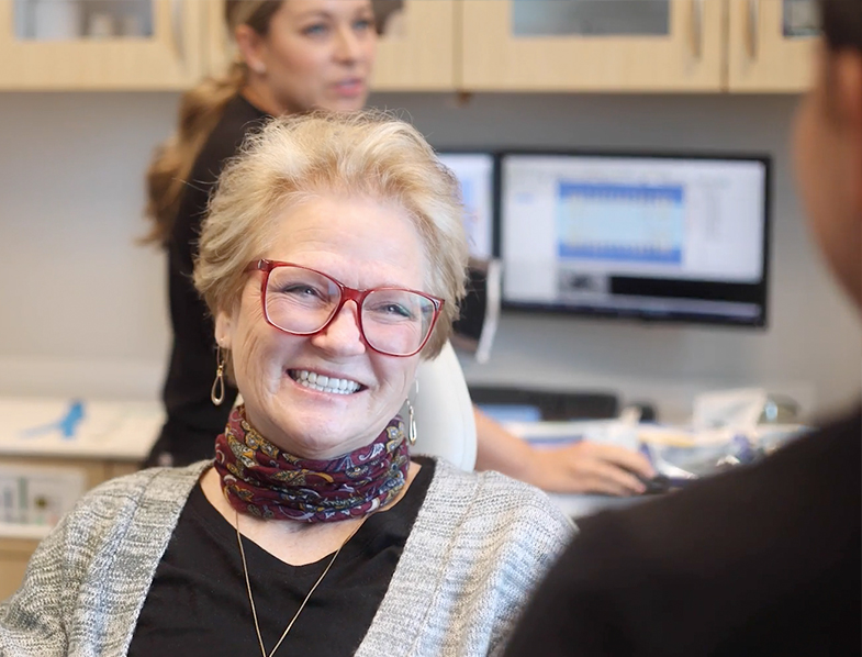 Senior woman smiling at her dentist