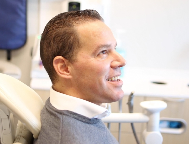 man smiling at his dentist