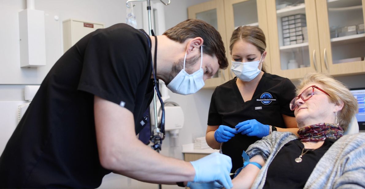 Dentist giving injection to patient