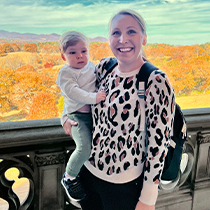 Doctor Megan smiling while holding baby