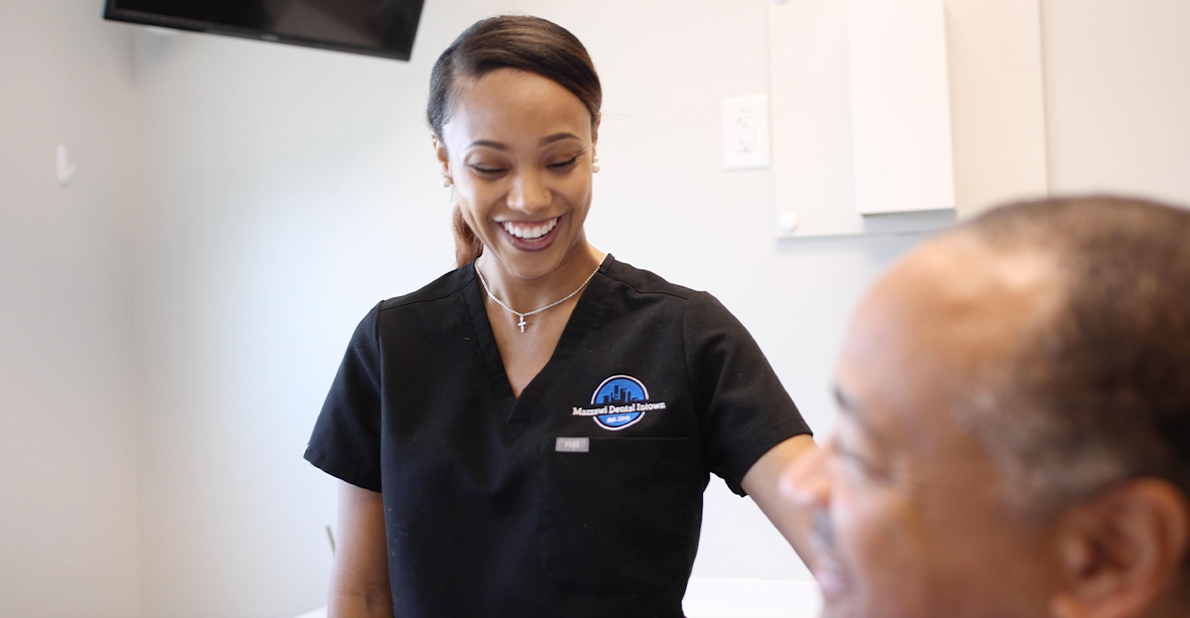 Dental team member treating a patient