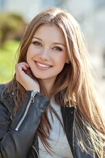 Young woman in leather jacket smiling