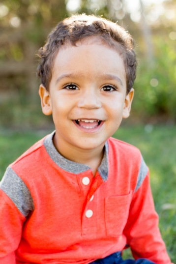 Smiling child in orange shirt