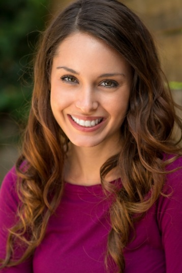 Woman in magenta blouse grinning