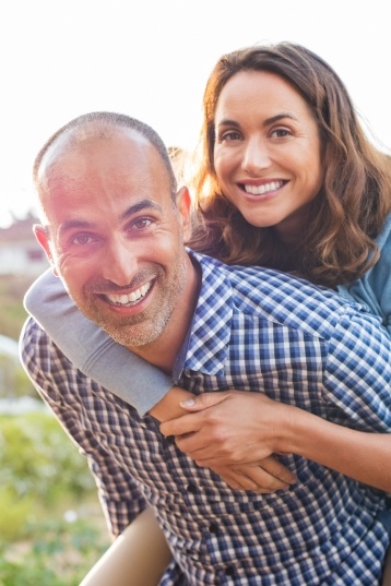 Man and woman holding each other outdoors