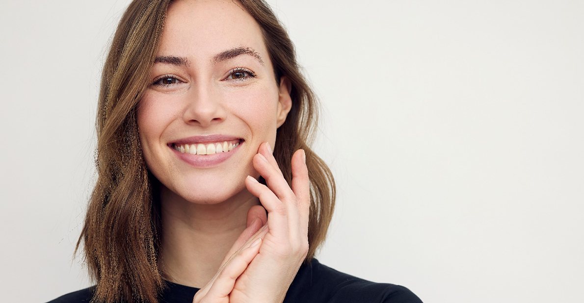 Close-up of a woman in a black shirt smiling